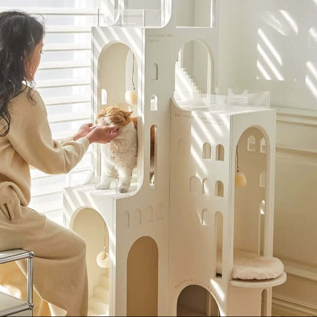Cat castle with ambient light, showcasing a cat and a person interacting in a stylish indoor setting.