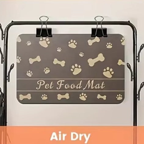 Pet feeding mat with bone and paw prints design, demonstrating an absorbent, waterproof solution for pet feeding.