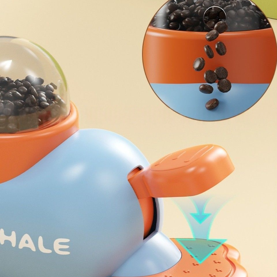 Interactive feeder designed for pets, shaped like a playful whale with food dispensed through a tail mechanism.