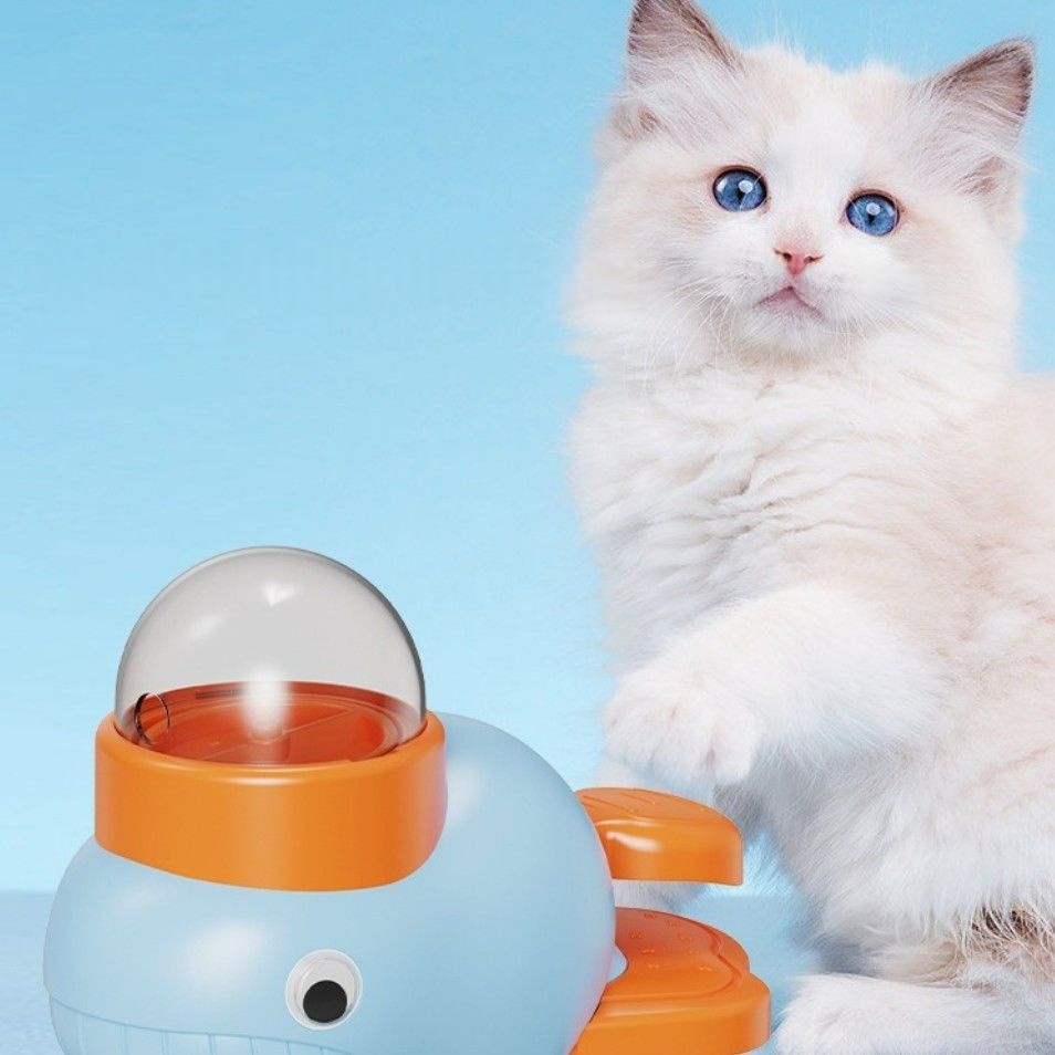 A fluffy white cat interacts with the interactive feeder The Quack & Snack™, a fun feeding toy.