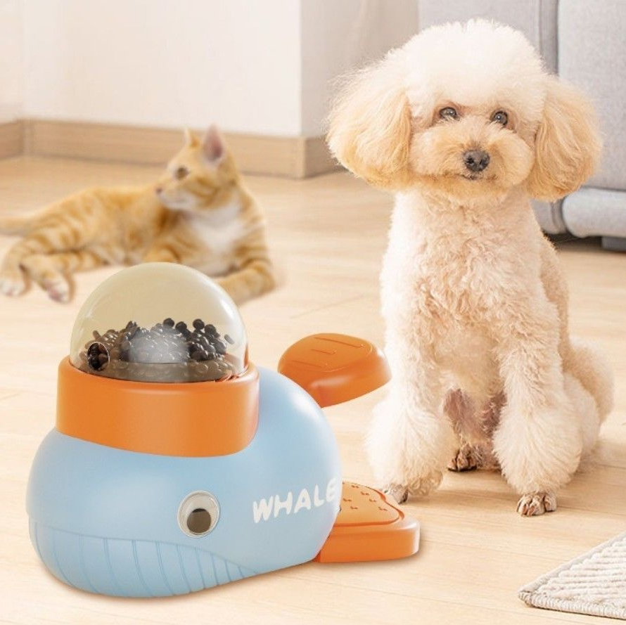 Interactive feeder in whale shape designed for cats and dogs, featuring a playful way to dispense treats.