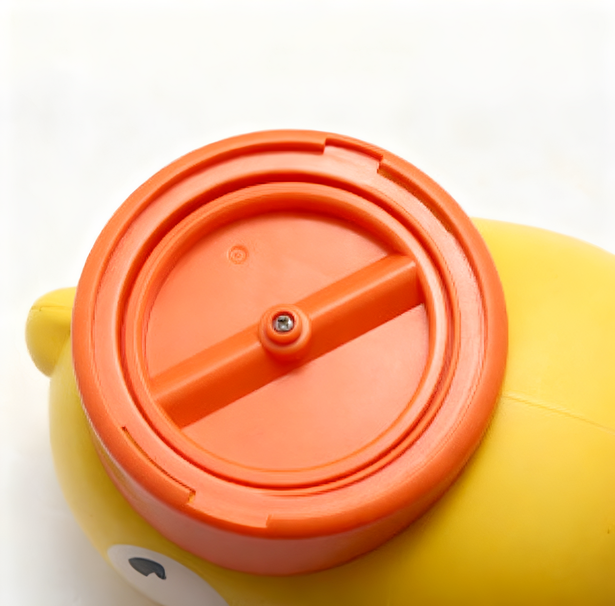 Interactive feeder with orange cap design for engaging pet feeding.