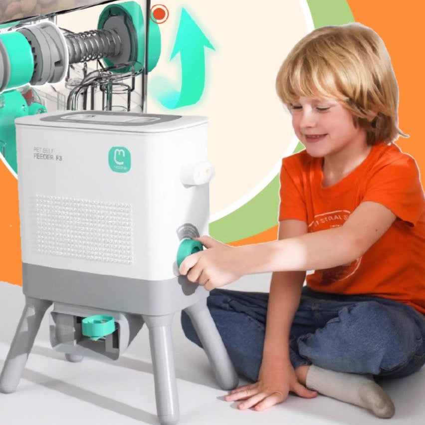 A young child operating the Pet Feeding Station The Artisan™ Customizable Paw, featuring a modern design for cats and dogs.
