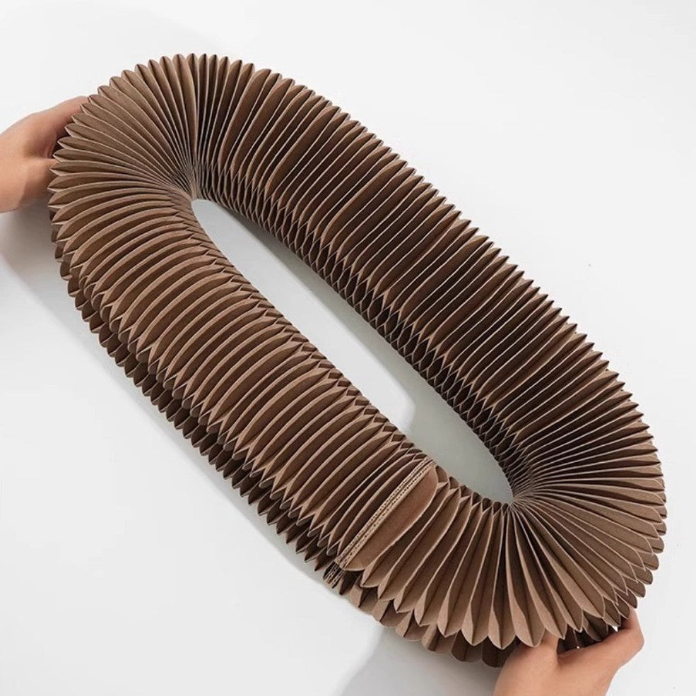 Cat scratcher with ball shown as a foldable board with pleated design, perfect for feline play and scratching.