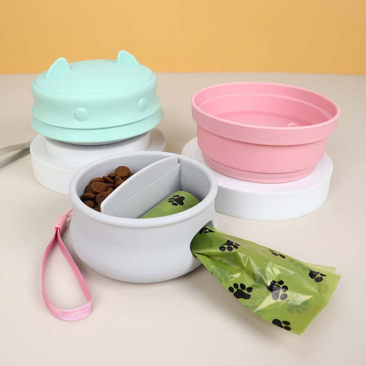 3-in-1 portable pet travel box featuring collapsible bowls and waste bag holder in pink and teal.