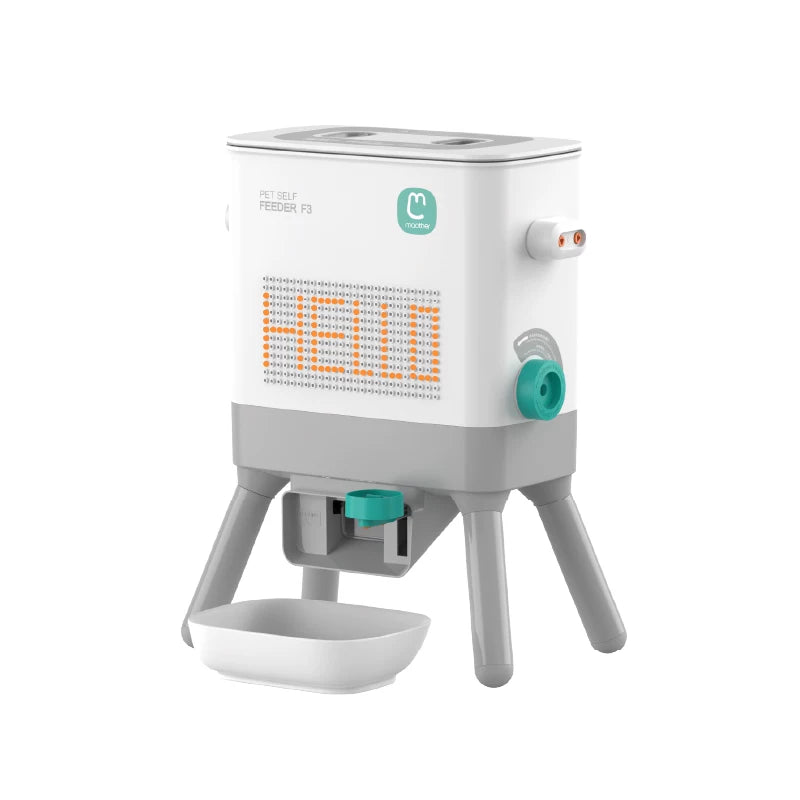 Pet feeding station featuring a modern automatic feeder with a digital display and a food bowl, designed for cats and dogs.