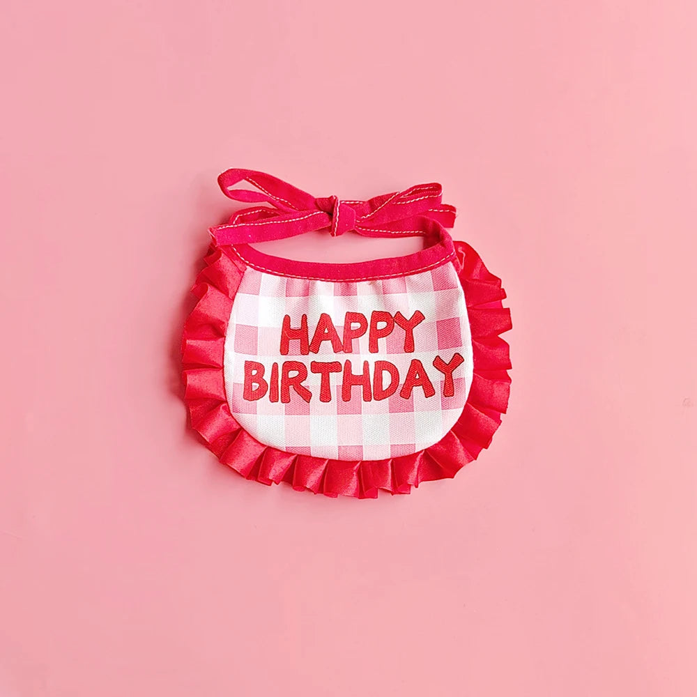 Small dog wearing birthday scarf and hat set for celebration or party