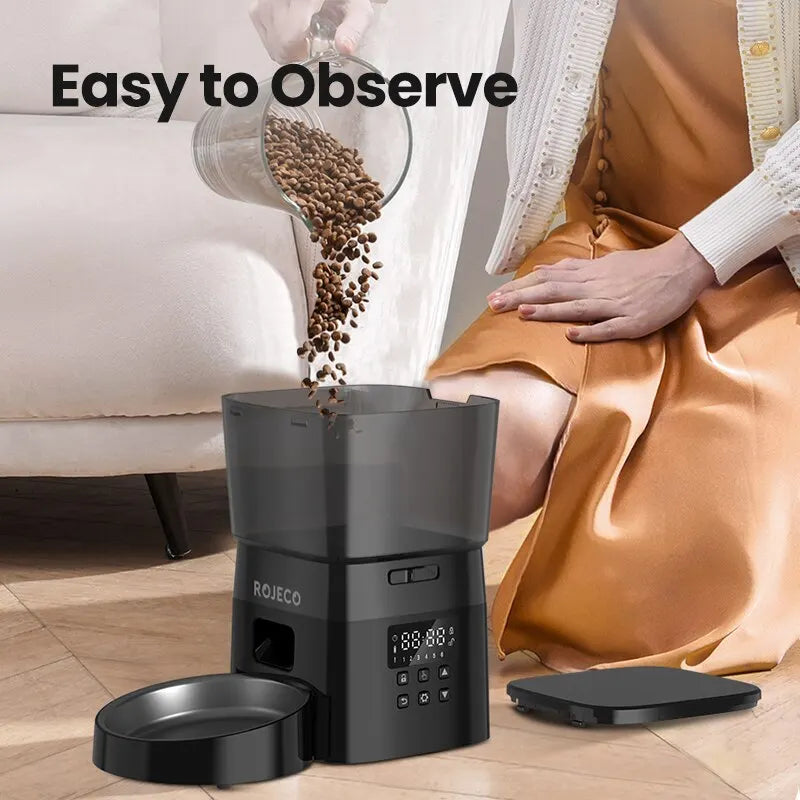 Automatic pet feeder dispensing food, designed for easy observation and convenience for pet owners.