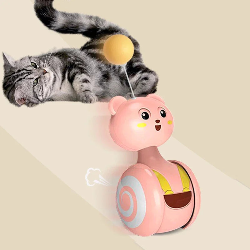 Swing tumbler cat toy with interactive spinning ball and feather wand, engaging a playful cat.