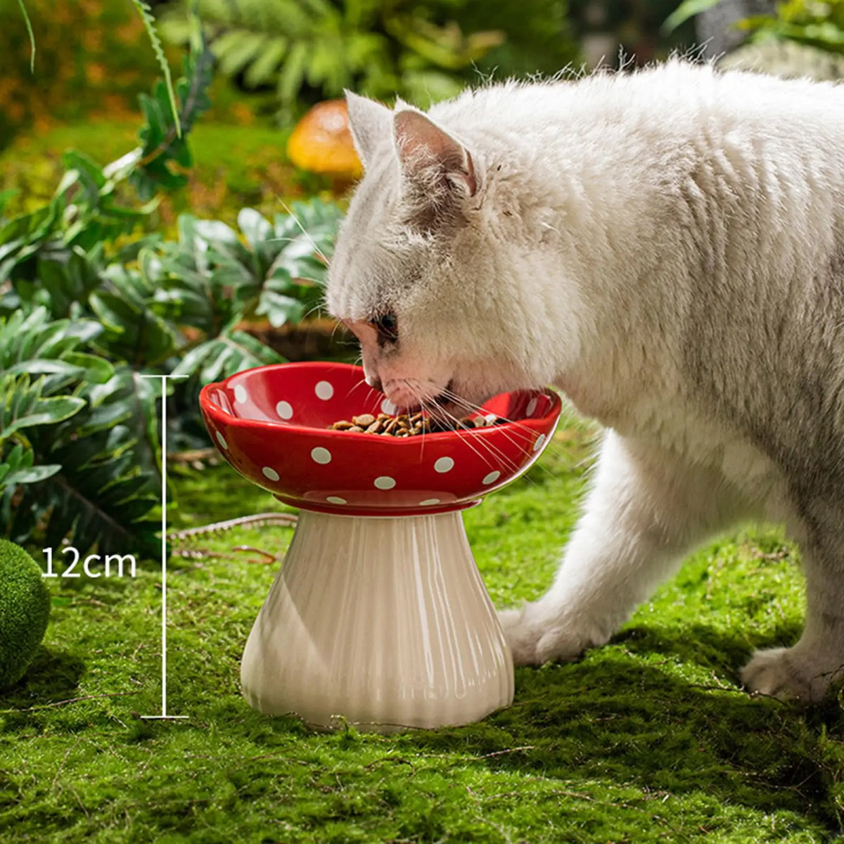 Ceramic cat feeder with mushroom elevated shelf and red bowl, designed for comfortable feeding.