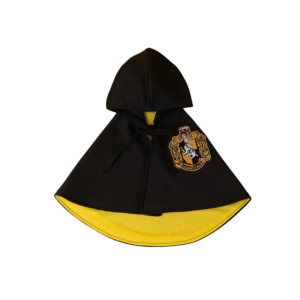 Cat or small dog wearing a shiny satin cape with magical Halloween theme.