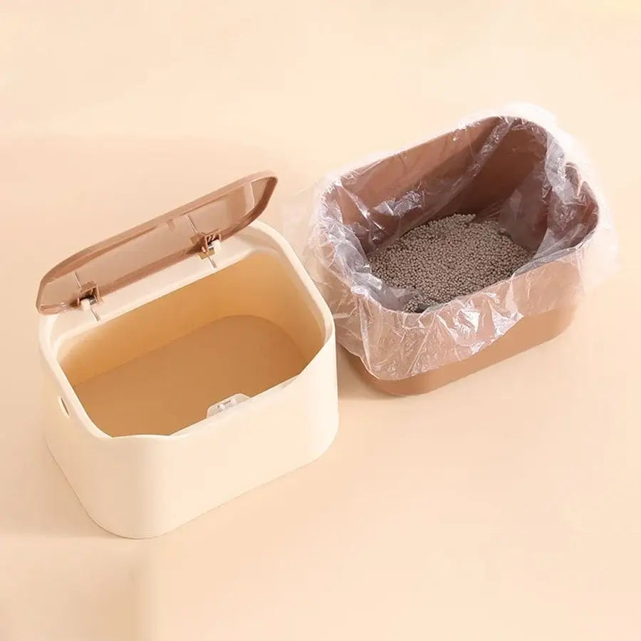 Compact enclosed cat waste box with sealed lid, odor-control design, and easy-carry handle for litter storage.