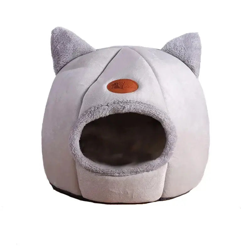 Deep sleep comfort cat bed in cave design, made with soft plush material and non-slip base for warm, cozy winter sleep.