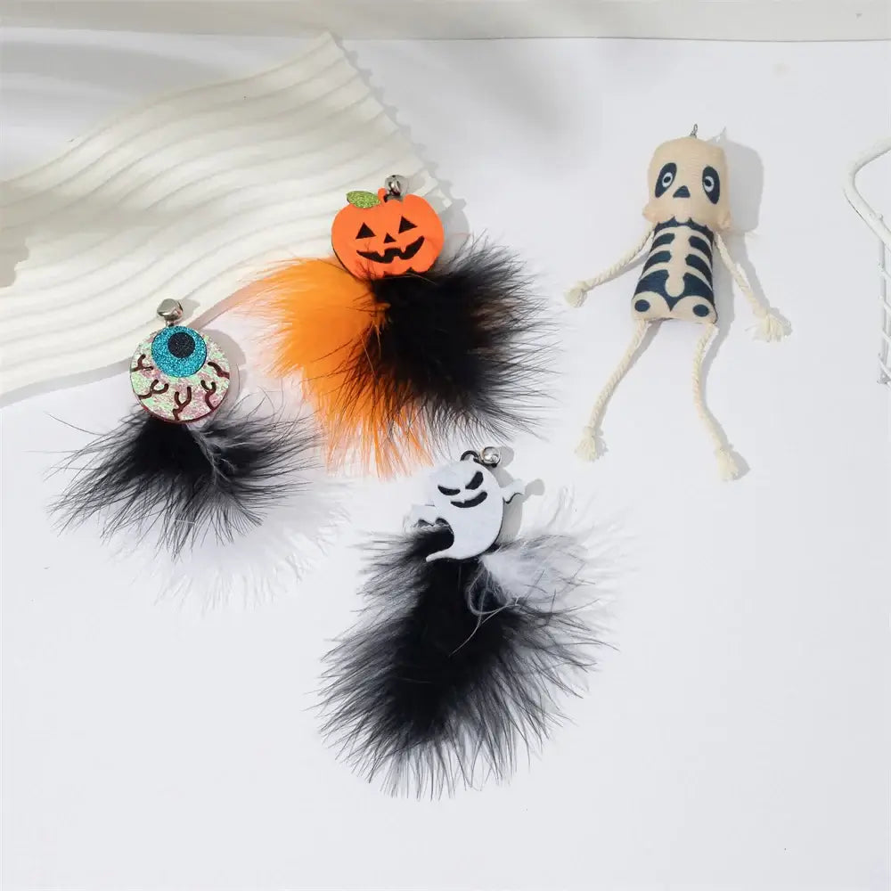 Halloween-themed cat teaser wand with pumpkin, ghost, feathers, and bell.