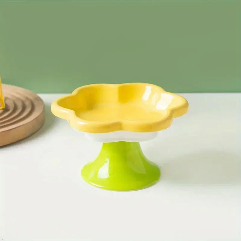 Elevated ceramic cat bowl with elegant flower design for comfortable and healthy feeding.