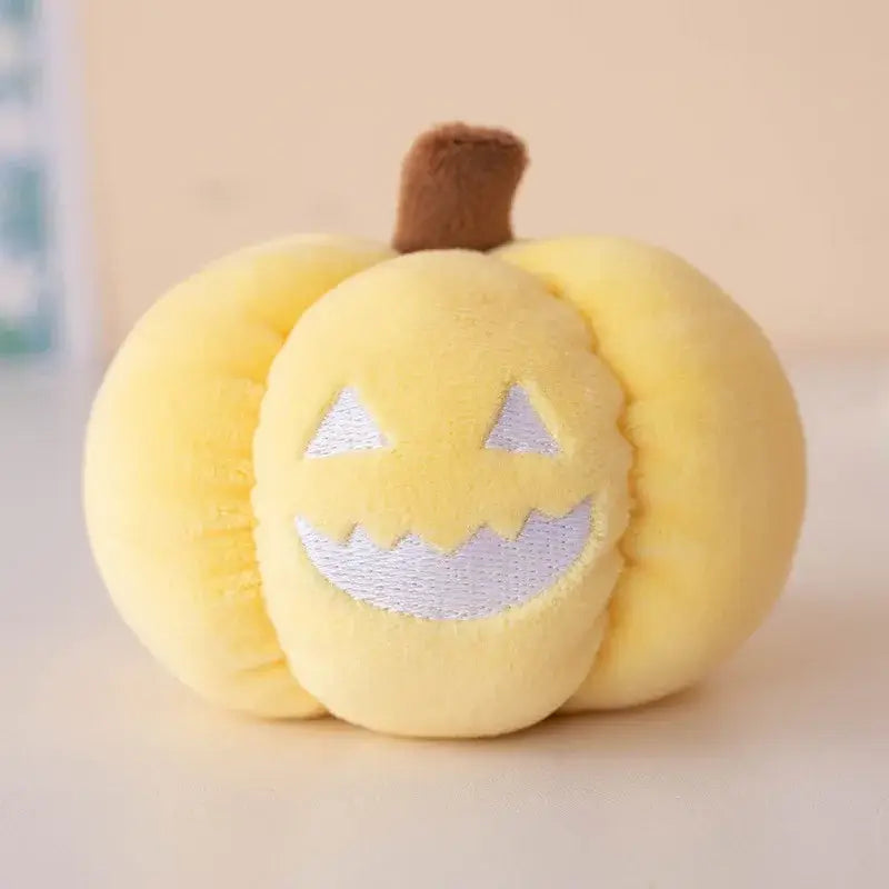 Small dog cuddling a Halloween pumpkin plush toy with night light.