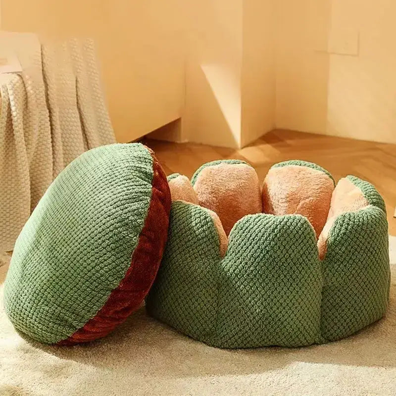 Small cat sleeping in a soft round plush pet bed with striped design