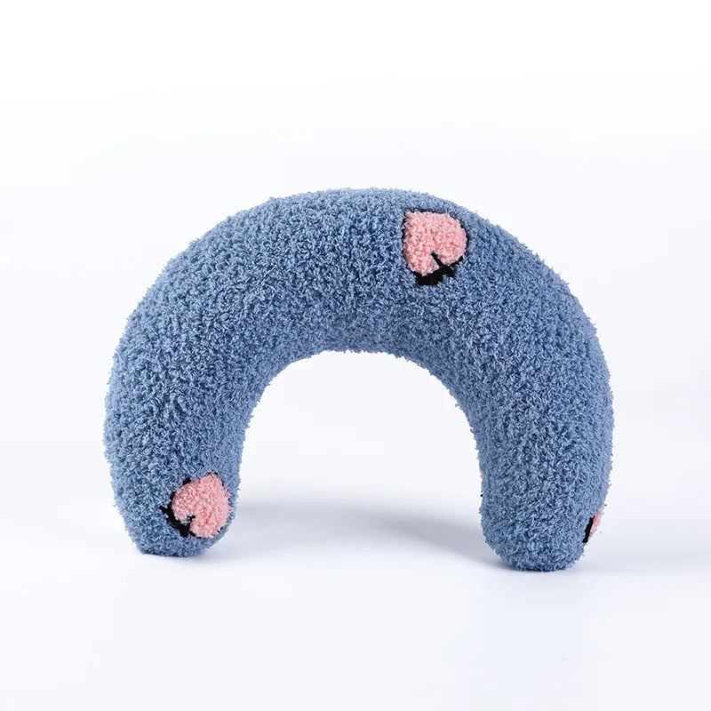 Cat resting on small U-shaped pet pillow in soft plush fabric