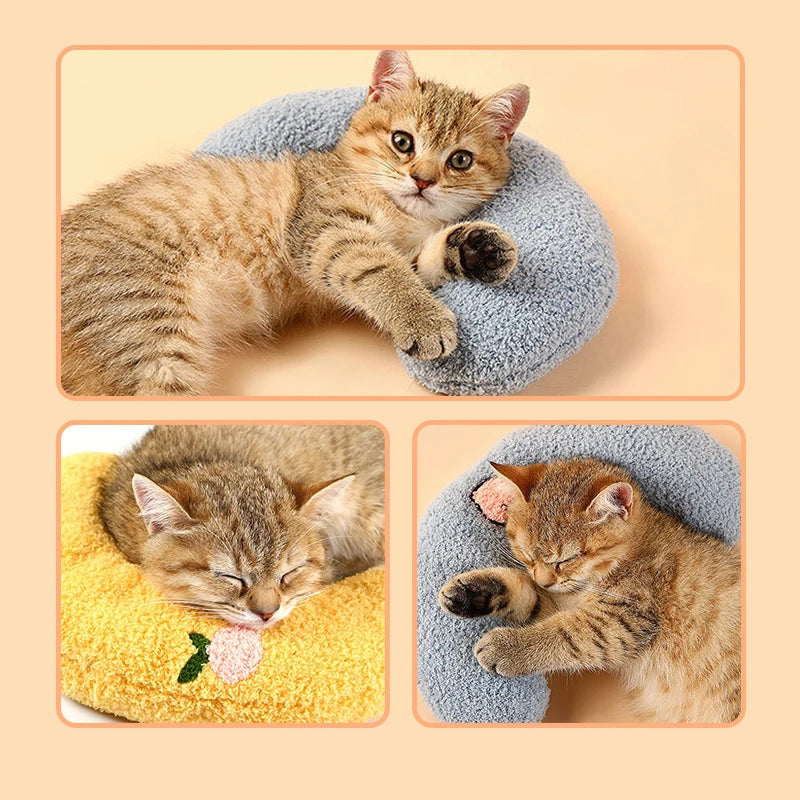 Cat resting on small U-shaped pet pillow in soft plush fabric