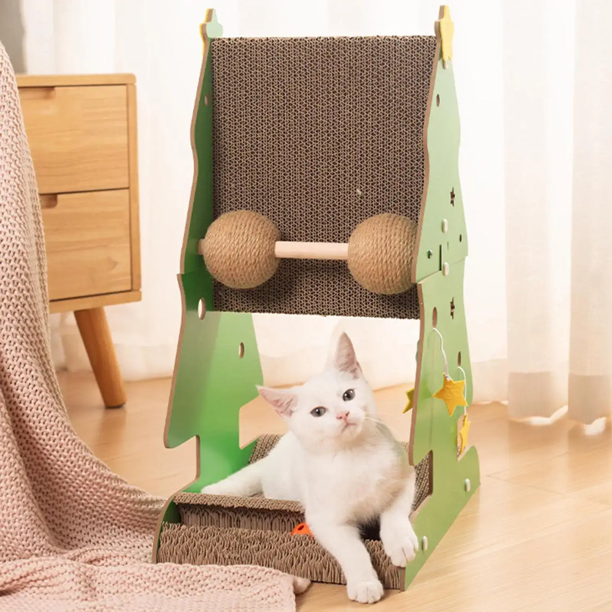 Holiday-themed sisal scratching tree for cats with Christmas design and cardboard toys.