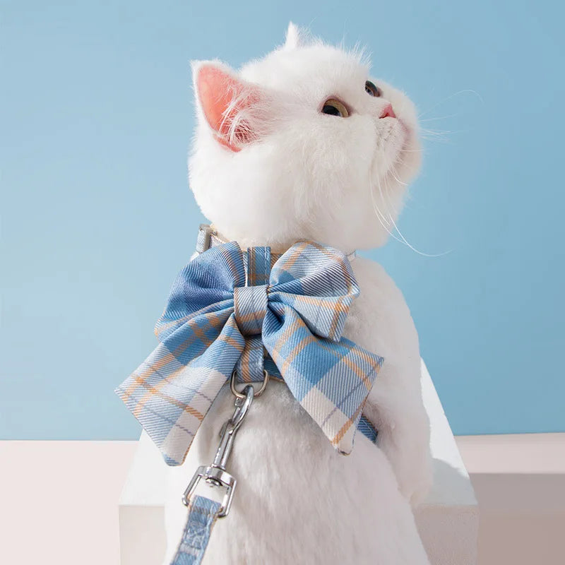 Pet harness with breast strap for cats, featuring a stylish blue plaid bow and adjustable leash.