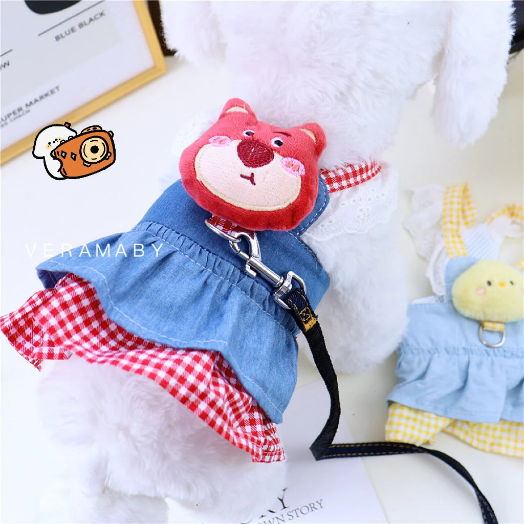 Small dog wearing pink doll-style harness with denim skirt and matching leash