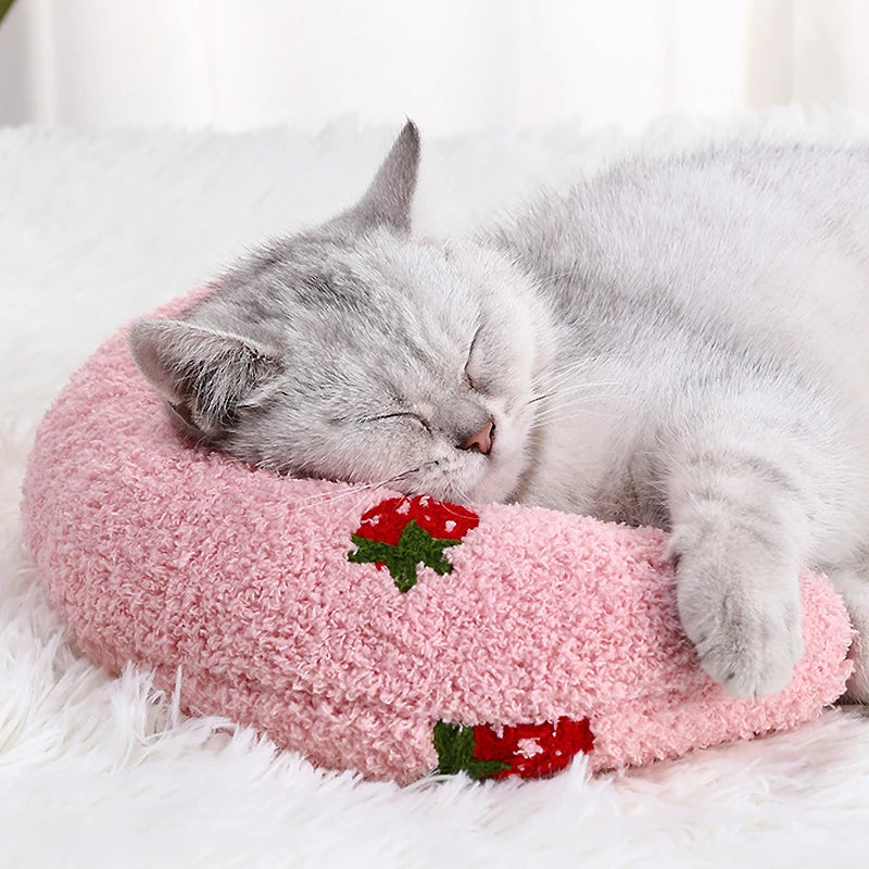 Cat resting on small U-shaped pet pillow in soft plush fabric