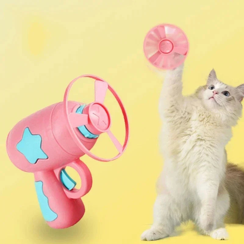 Cat jumping to catch a flying disc launched by interactive cat toy