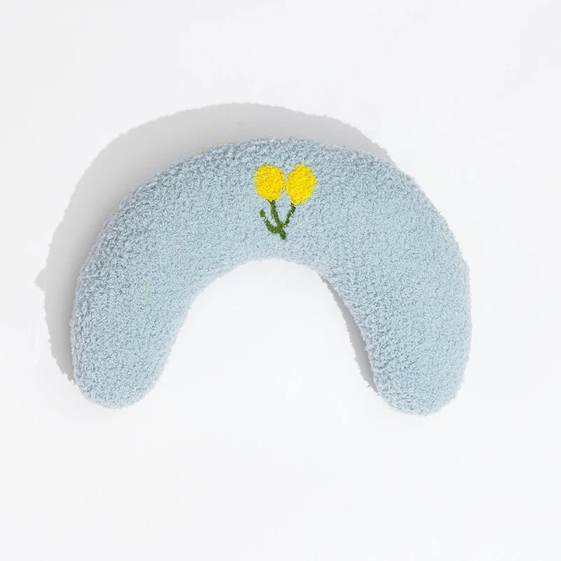 Cat resting on small U-shaped pet pillow in soft plush fabric