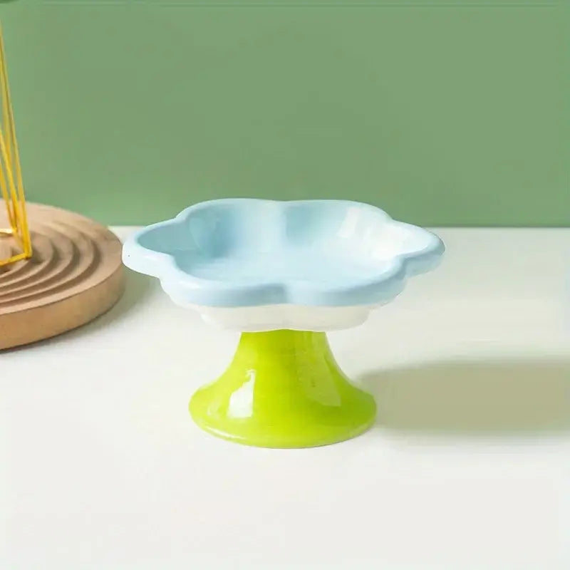 Elevated ceramic cat bowl with elegant flower design for comfortable and healthy feeding.