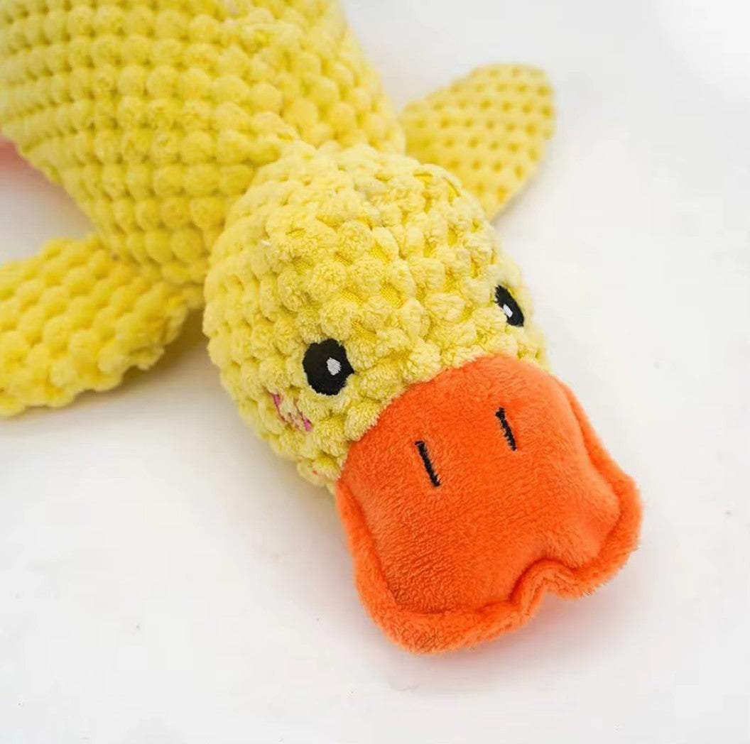 Calming pet toy in the shape of a cute yellow duck with an orange beak and textured body.
