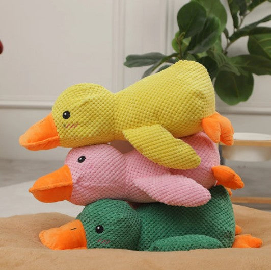 Stack of plush ducks in yellow, pink, and green colors, designed as a calming pet toy for dogs and cats.