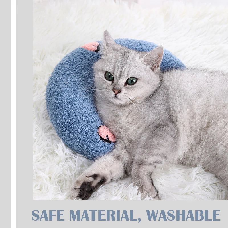 Cat resting on small U-shaped pet pillow in soft plush fabric