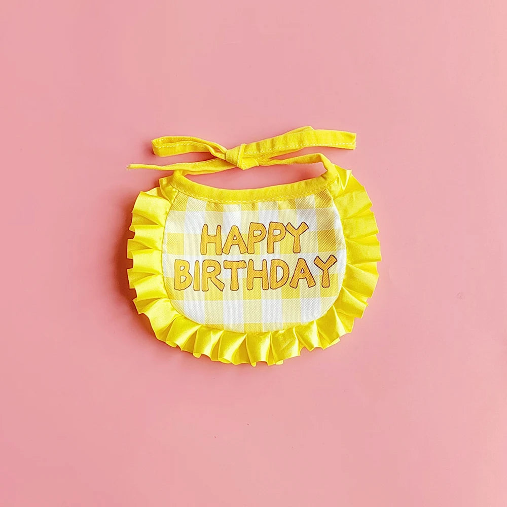 Small dog wearing birthday scarf and hat set for celebration or party