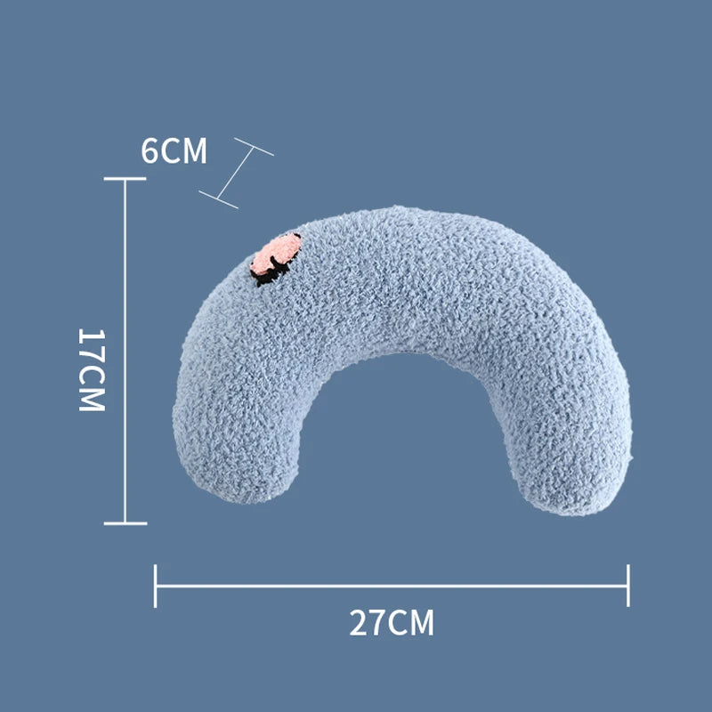 Cat resting on small U-shaped pet pillow in soft plush fabric
