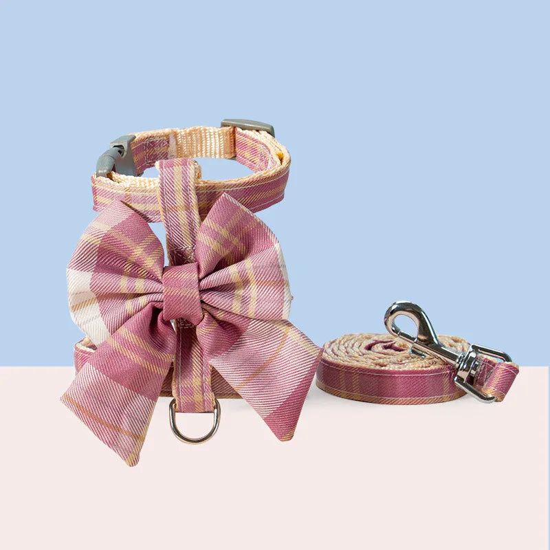 Pet harness design with stylish pink checkered pattern and matching leash featuring a large bow.
