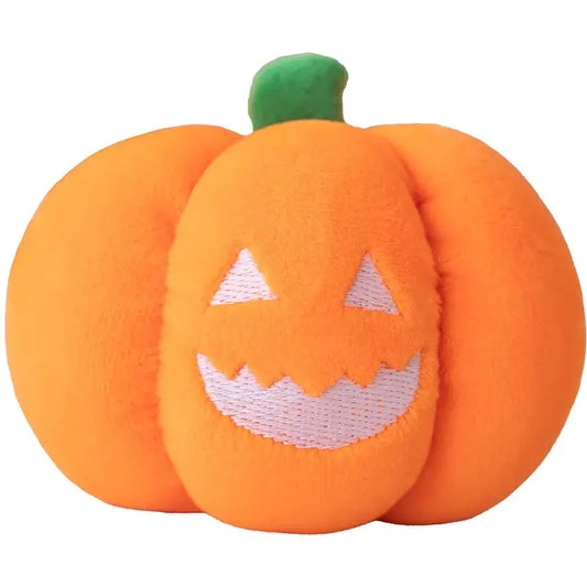 Small dog cuddling a Halloween pumpkin plush toy with night light.