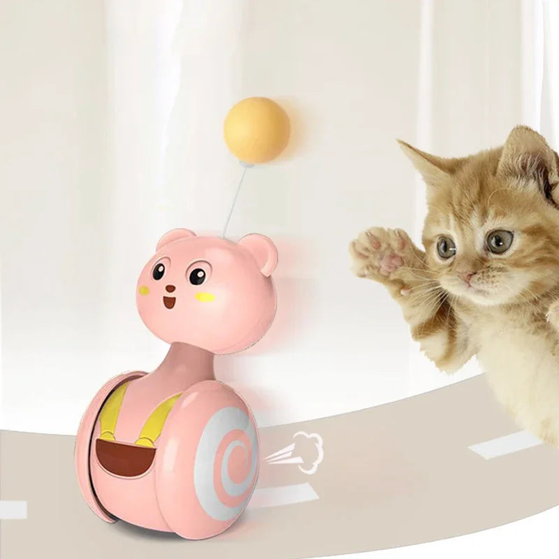 A playful kitten interacts with a swing tumbler cat toy, designed for energetic felines.