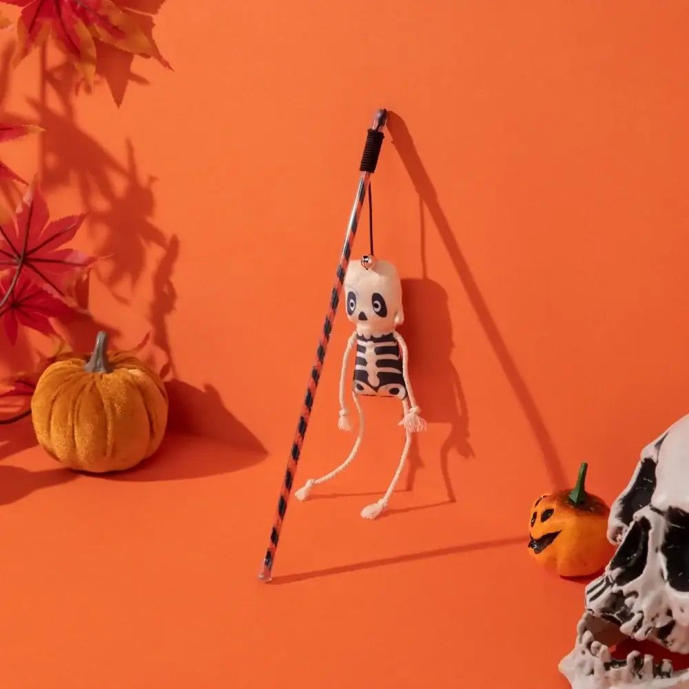 Halloween-themed cat teaser wand with pumpkin, ghost, feathers, and bell.